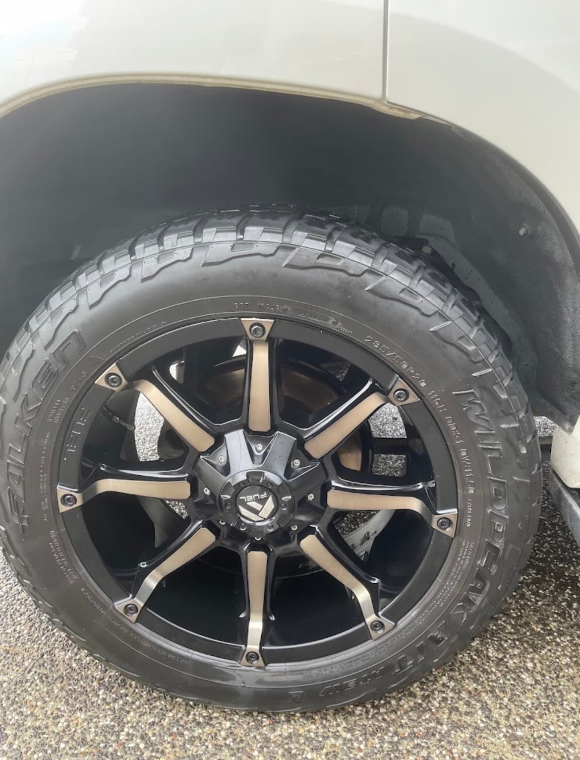 Black and bronze Fuel multi-spoke rim with a rugged Falken Wildpeak all-terrain tire.